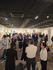 Visitors attending the opening reception of the international group exhibition Identity at Insa Art Center in Seoul, viewing artworks throughout the gallery.
